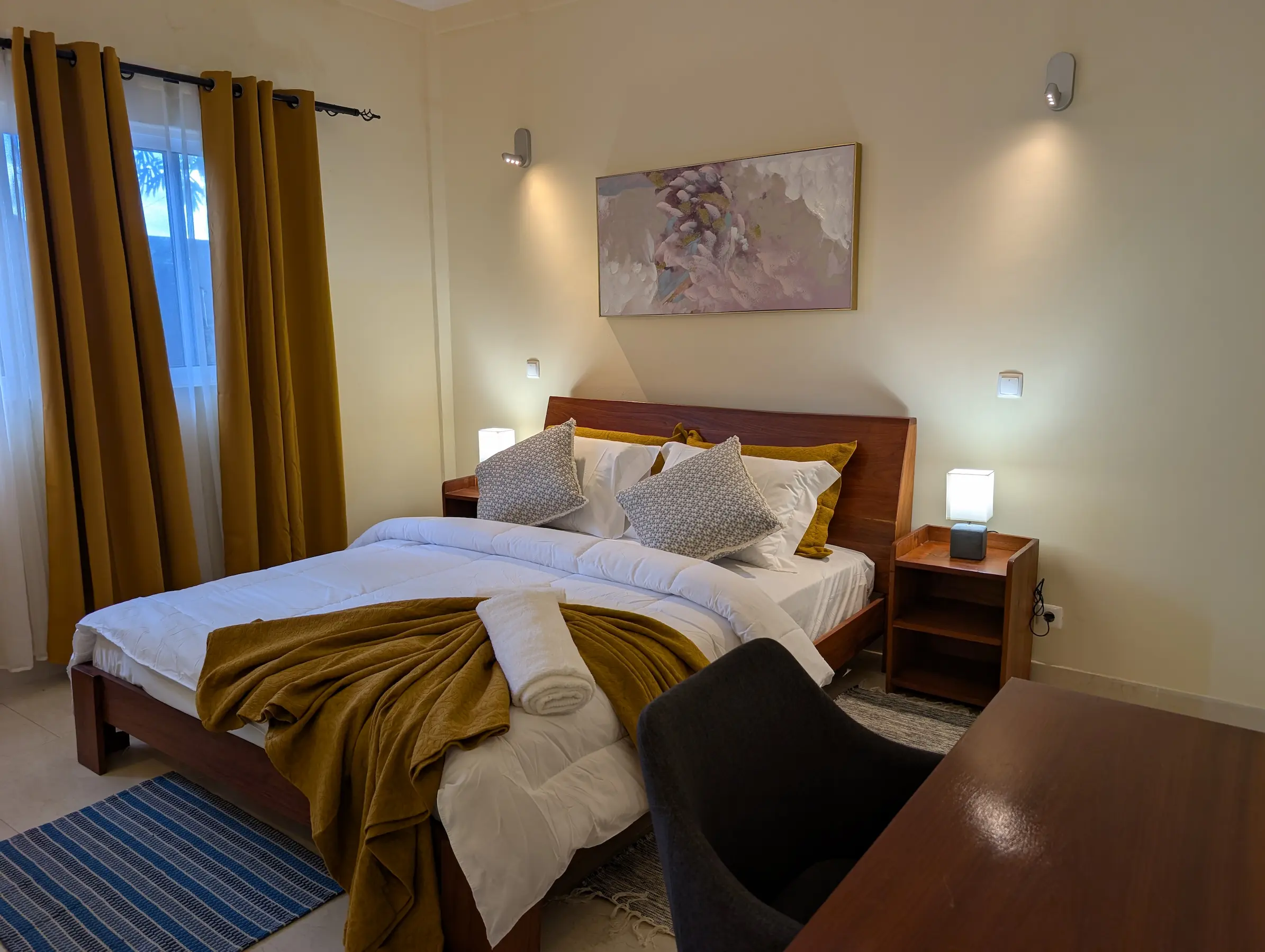 Cozy bedroom with mustard curtains and modern decor.